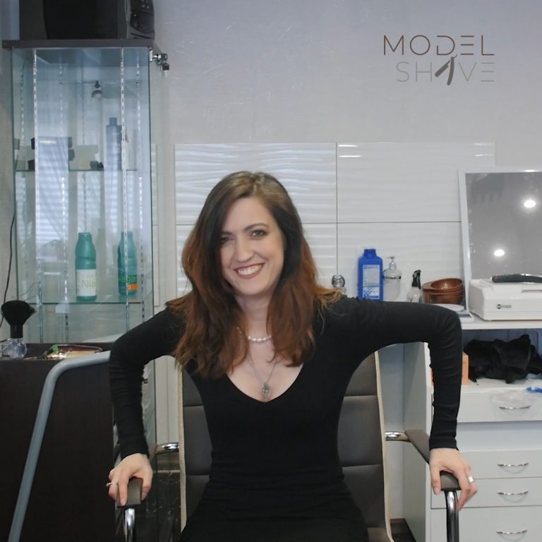 Woman at the to make a smooth shiny headshave. Model Shave