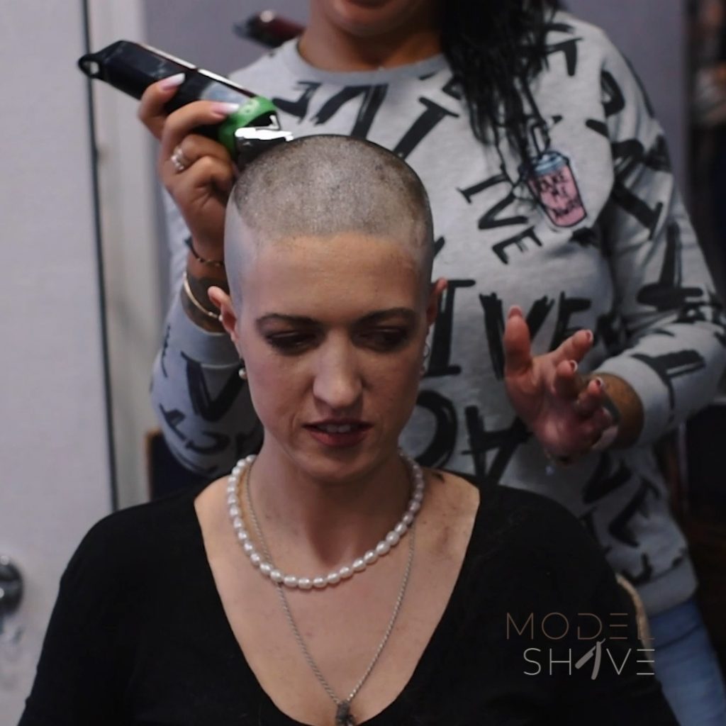 Woman at the barbershop to make a smooth shiny headshave. - Model Shave